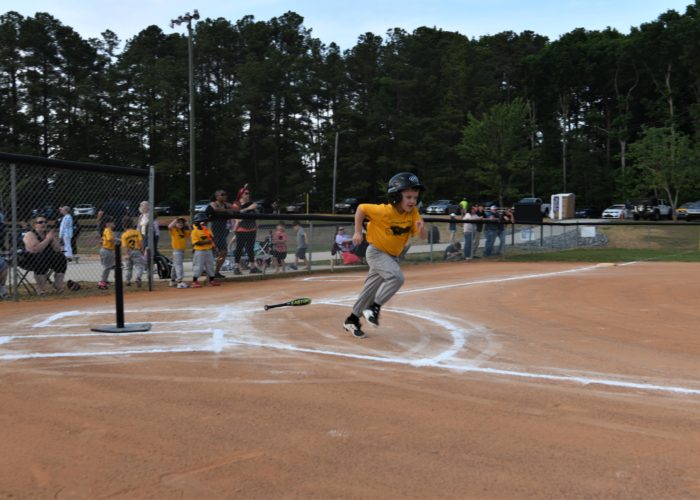 Small child runs to first base in tee-ball game. Credit: Lee County Government